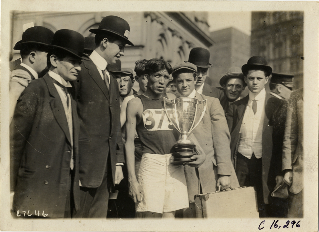 Runner Louis Tewanima holding trophy, 1911 Evening Mail Modified Marathon
