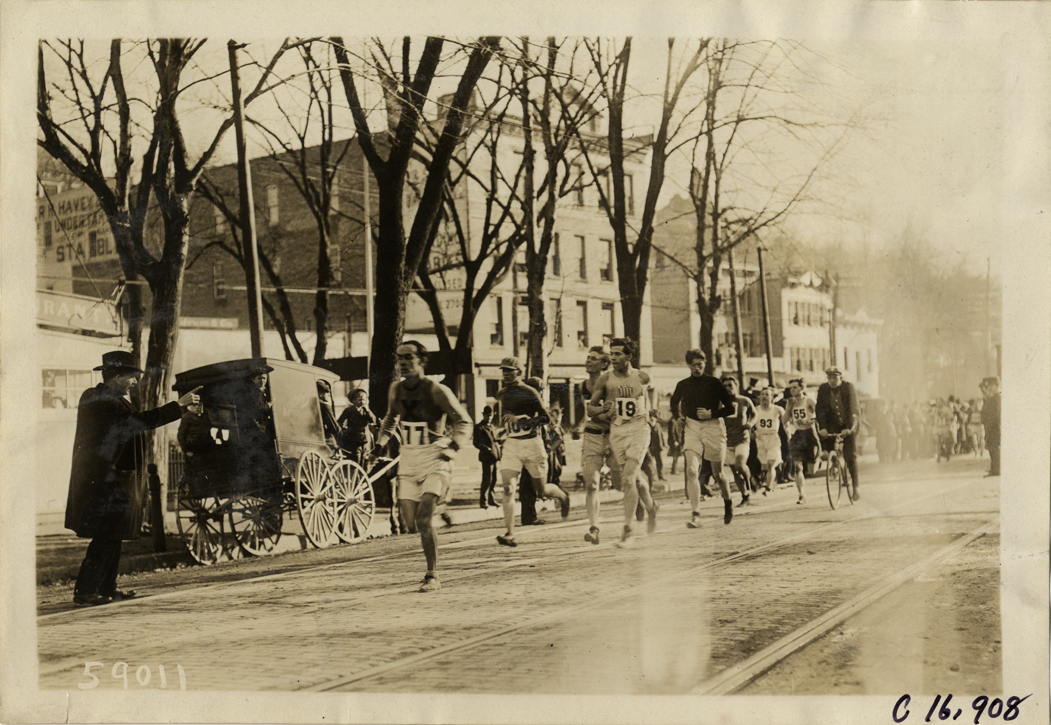Bicyclist following marathon runners