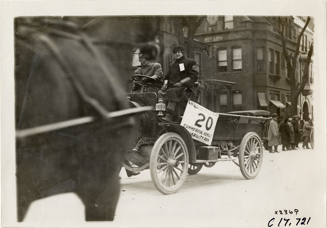 Driver and passenger in truck, 1910 Chicago Motor Truck Run