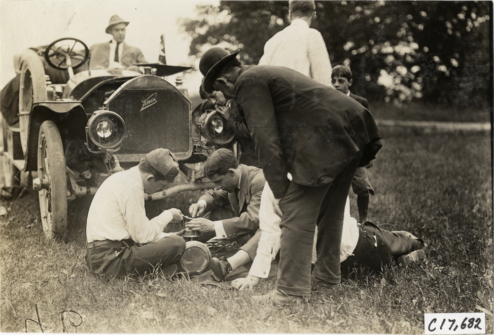 Men fixing Klaxon horn for Knox automobile, 1909 Catskill-Berkshire Tour