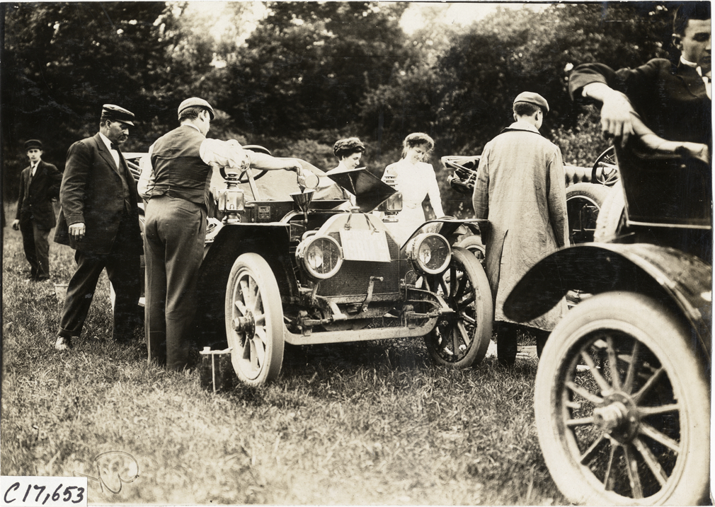 Harry Fosdick adding oil to Lancia automobile, 1909 Catskill-Berkshire Tour