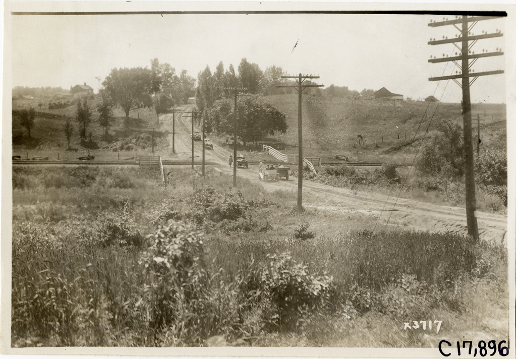Trucks traveling on rural road, 1911 Chicago Reliability Run