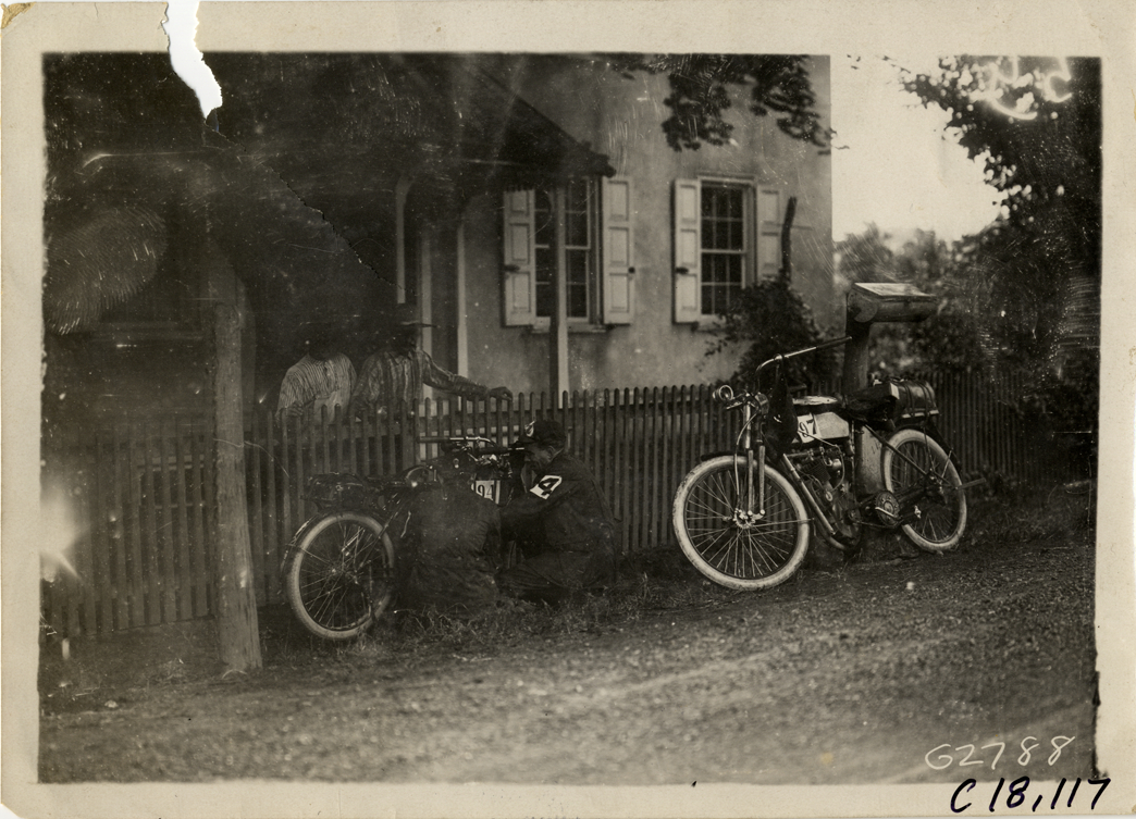 Motorcyclists fixing motorcycle, 1910 Federation of American Motorcyclists Endurance Run