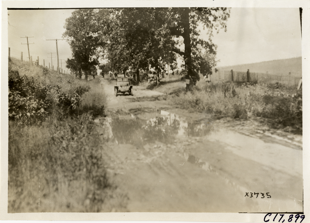 Trucks traveling on rural road, 1911 Chicago Reliability Run