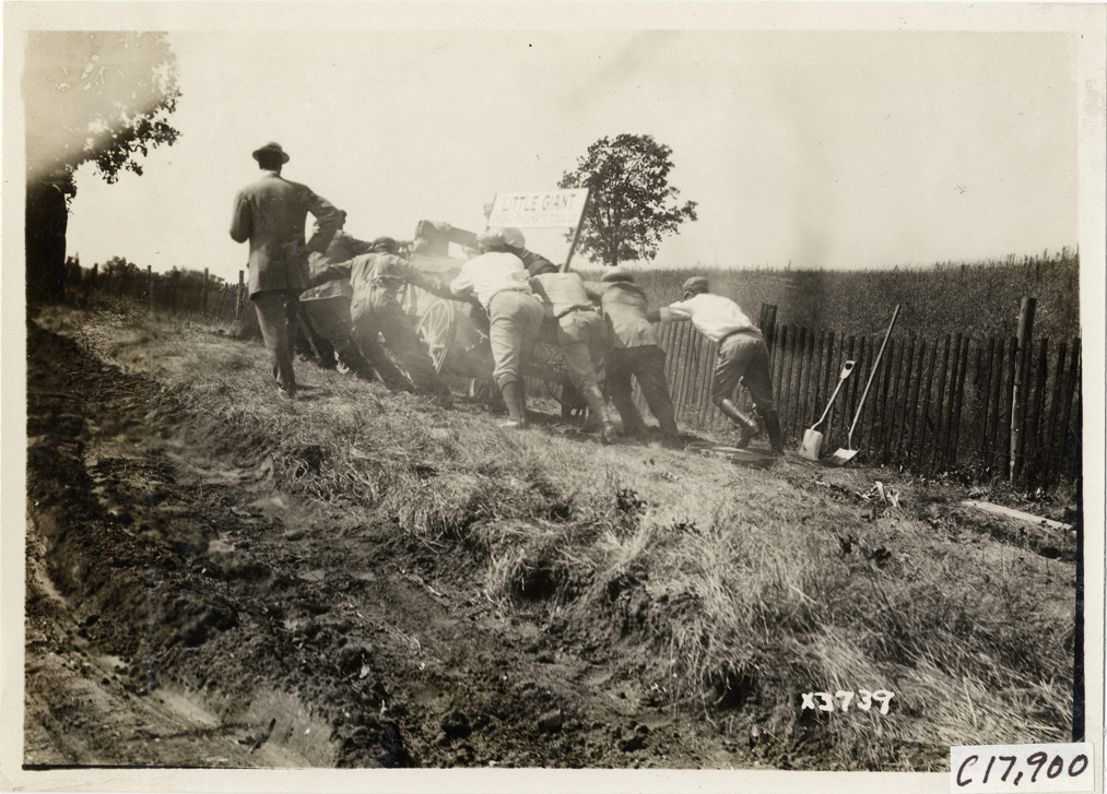 Men pushing Little Giant truck on rural road, 1911 Chicago Reliability Run