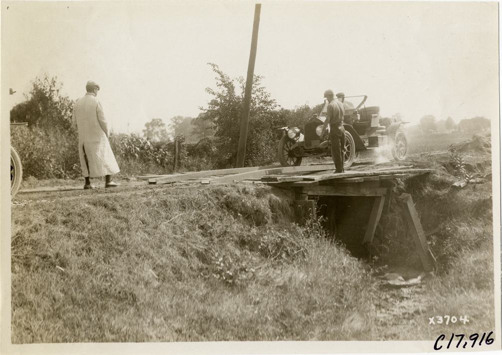 Men guiding automobile over bridge, 1911 Chicago Reliability Run