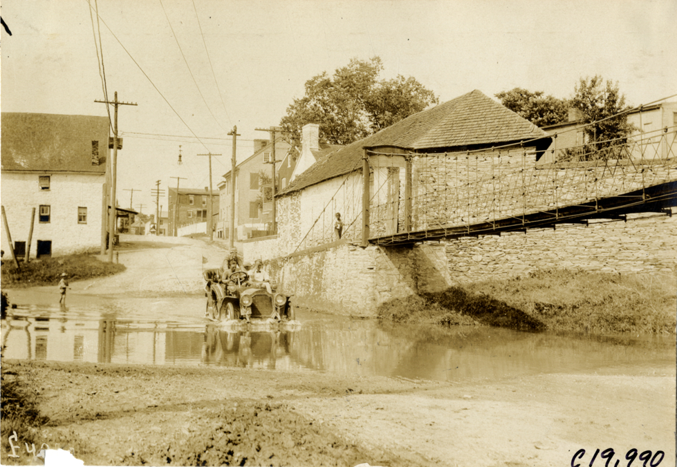 Motorists in automobile crossing canal, Fredericksburg, Pennsylvania, 1907 Glidden Tour