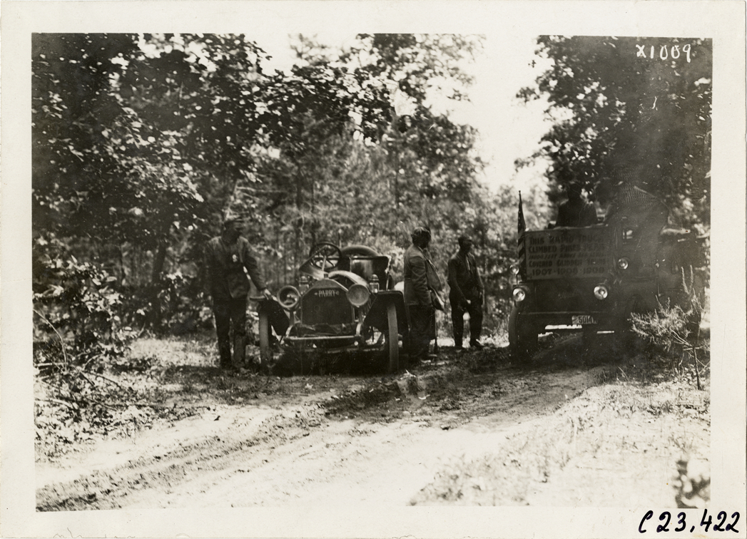 Motorists with Rapid truck and Parry automobile in forest, 1910 Glidden Tour