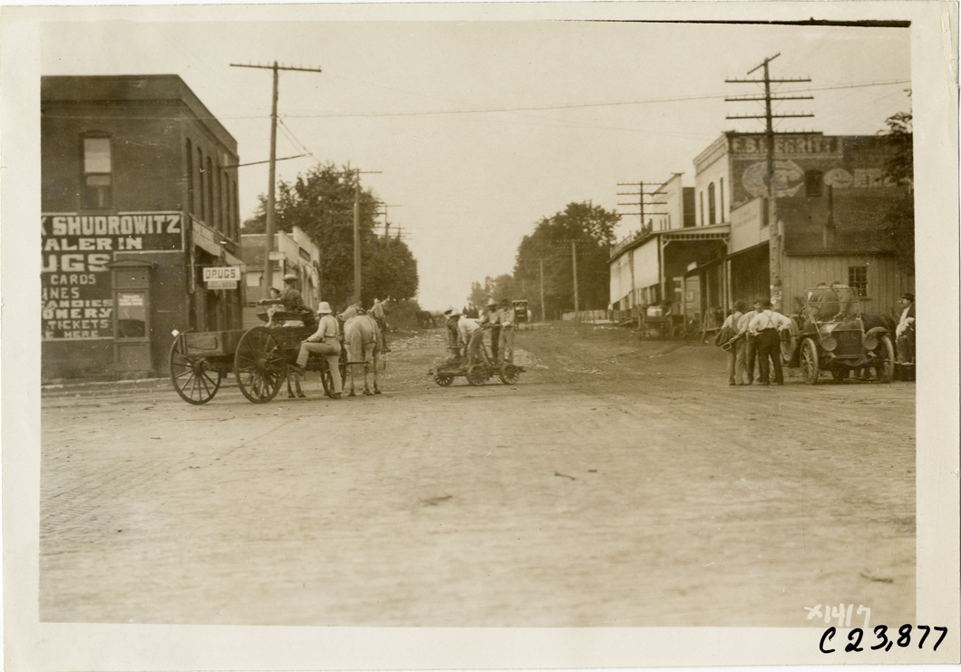 Men riding handcar in middle of road, 1910 Glidden Tour