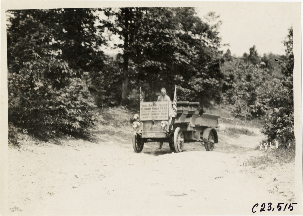 Motorist in Rapid truck traveling on rural road, 1910 Glidden Tour