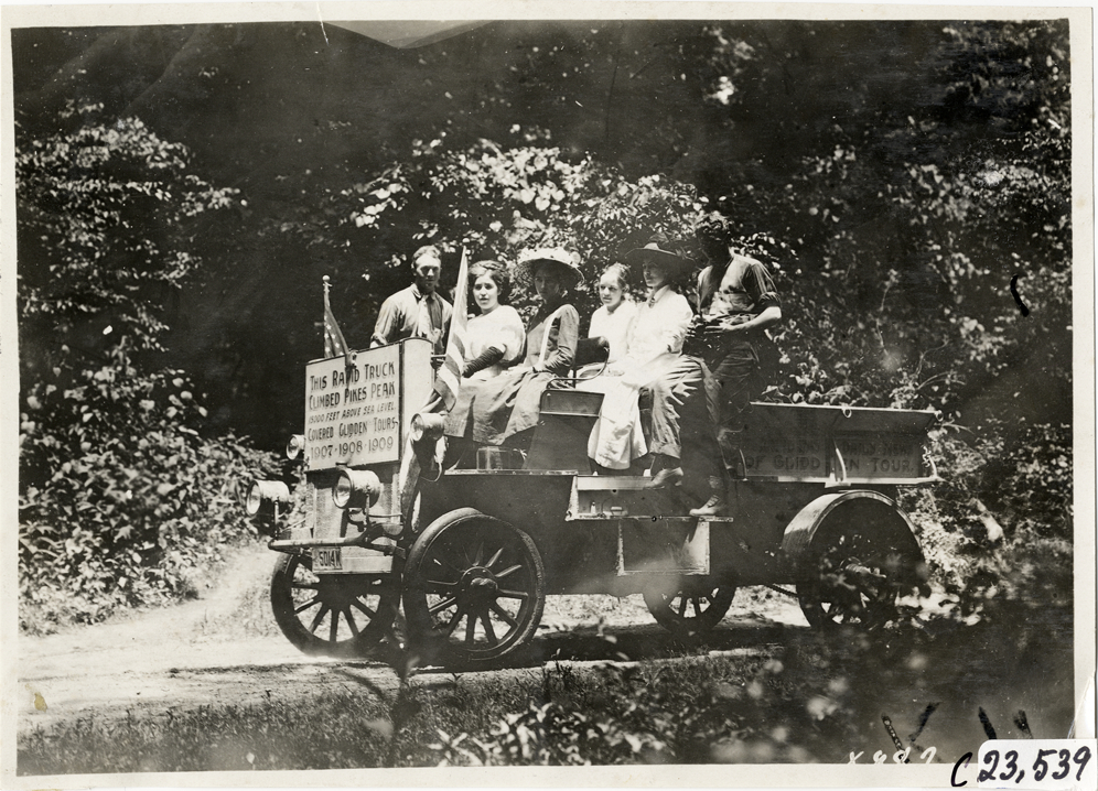Women posing with motorists in Rapid truck, 1910 Glidden Tour