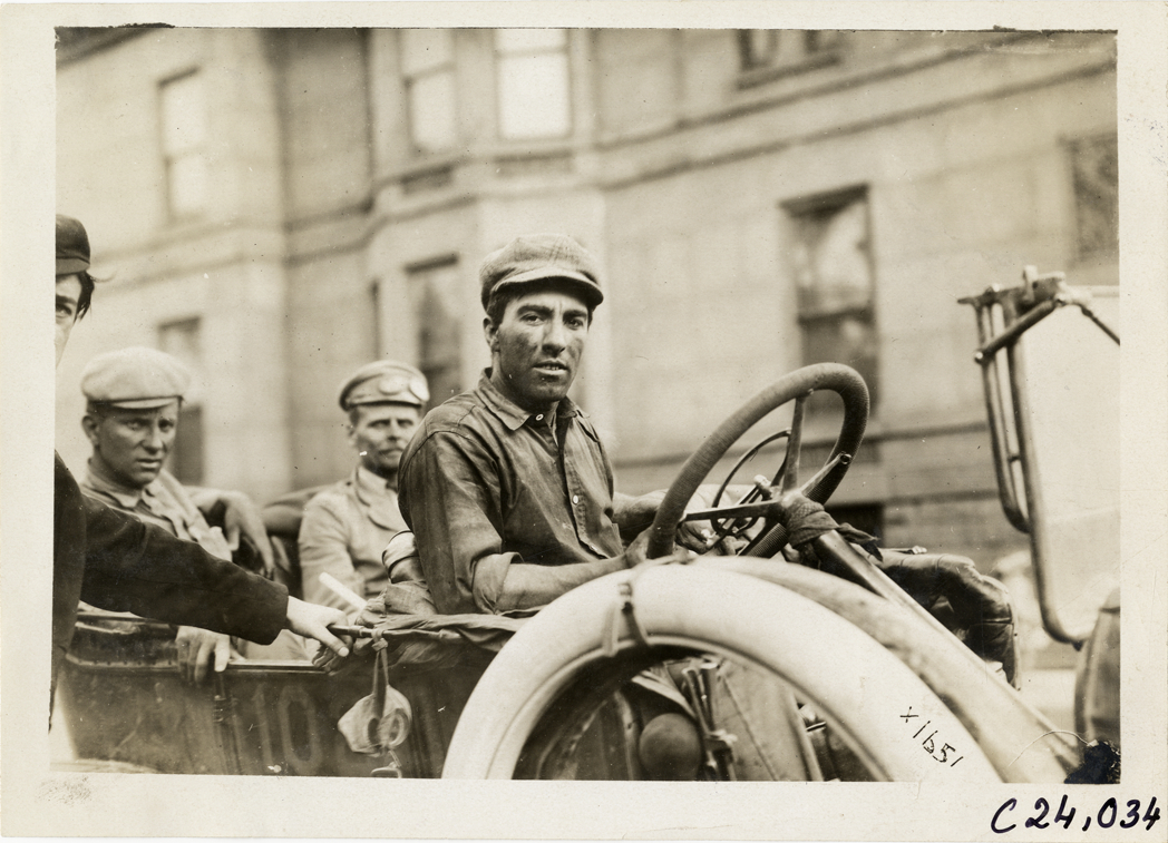 Driver posing in Moline automobile, 1910 Glidden Tour