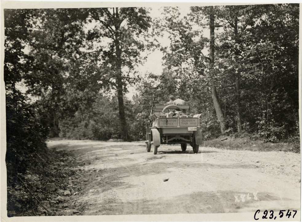Motorists in Rapid truck traveling on rural road, 1910 Glidden Tour