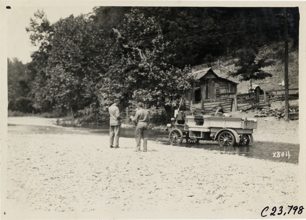 Rapid truck on flooded stretch of rural road, 1910 Glidden Tour