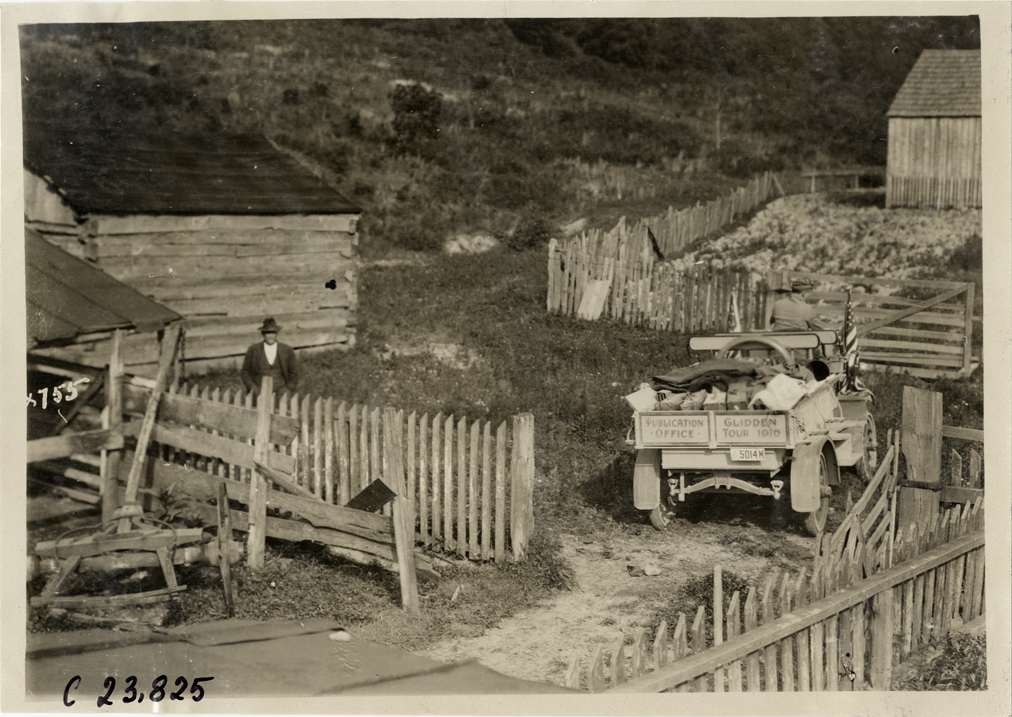 Rapid truck parked in farmyard, 1910 Glidden Tour