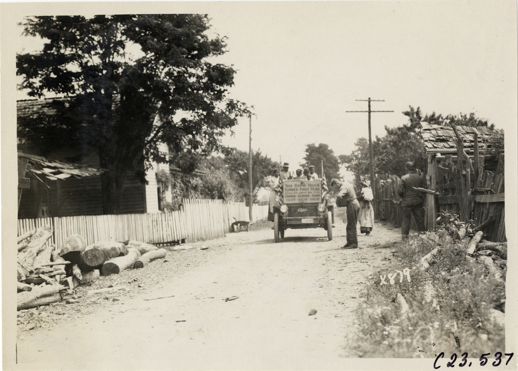 Children in Rapid truck on rural road, 1910 Glidden Tour