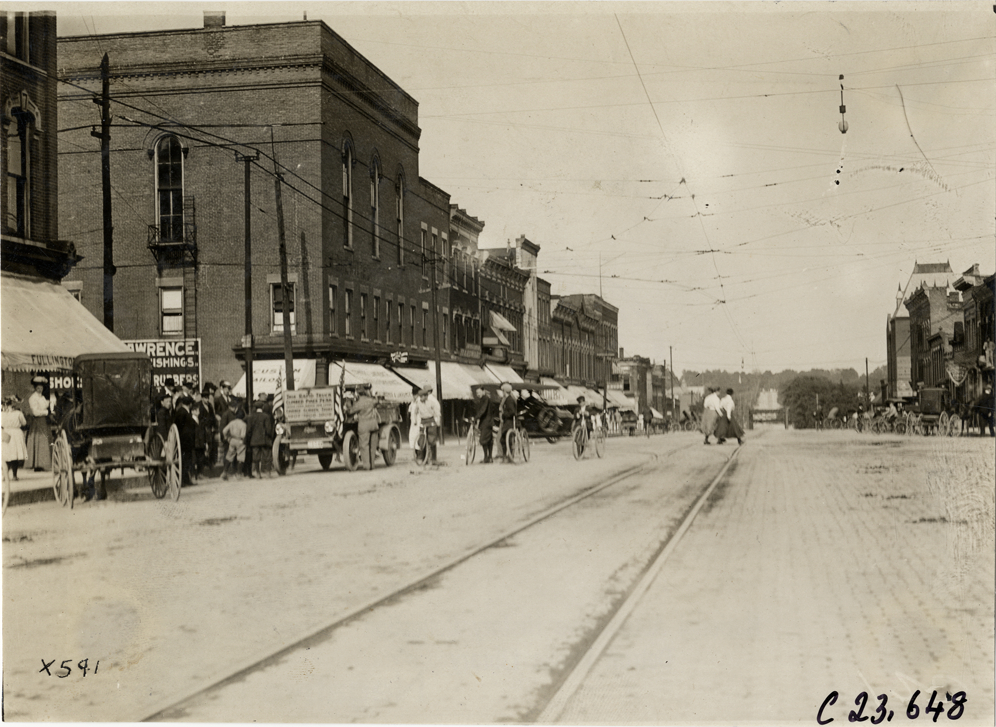 Motorists with Rapid truck in street, 1910 Glidden Tour