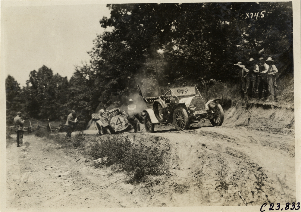 Chalmers automobile stuck on dirt road, 1910 Glidden Tour