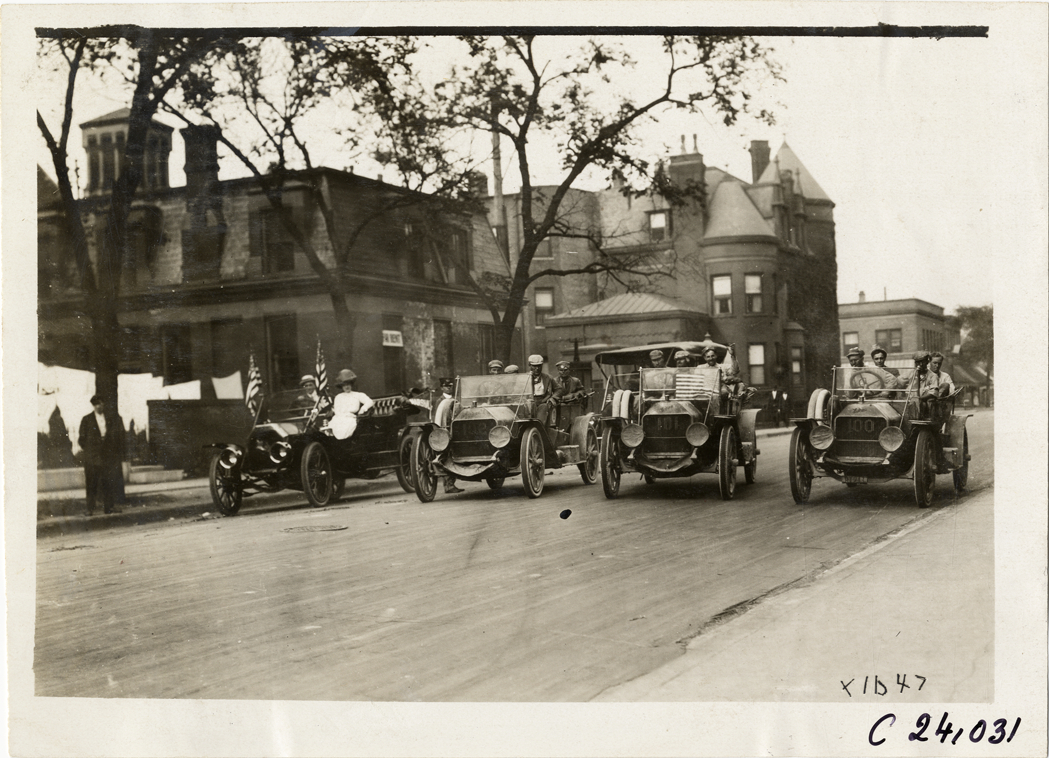 Moline automobiles lined up in street, 1910 Glidden Tour