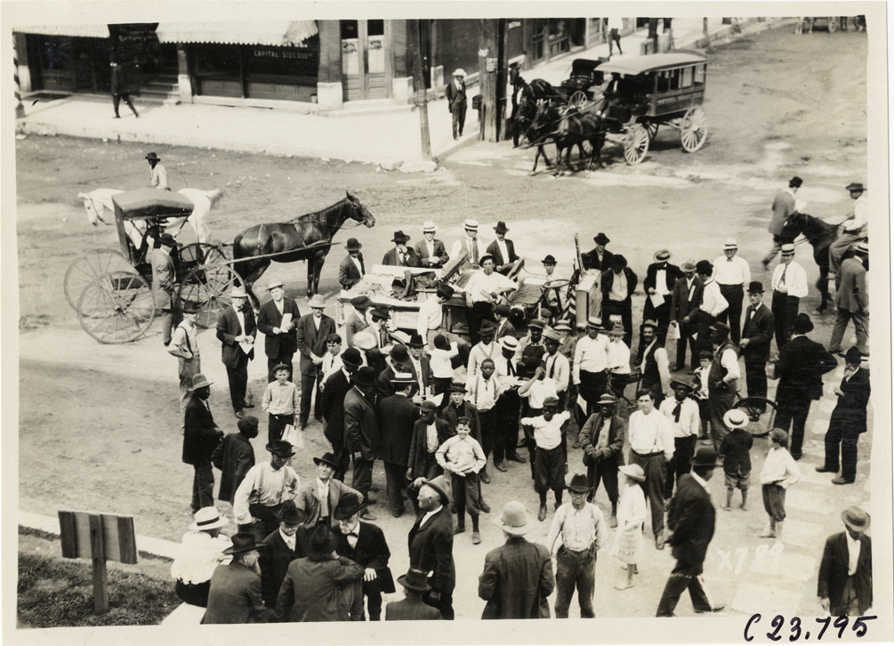 Spectators surrounding Rapid truck in street, 1910 Glidden Tour