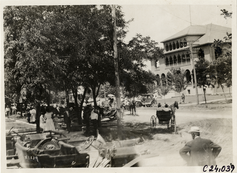 Automobiles and horse-drawn vehicles in front of Elks lodge, 1910 Glidden Tour
