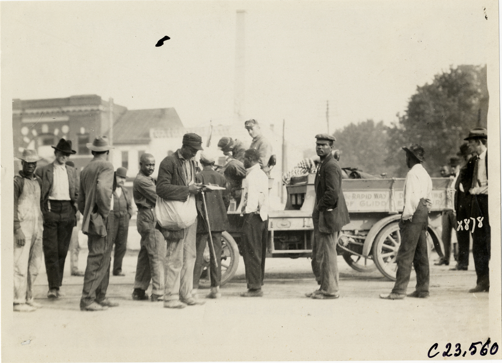 Spectators surrounding motorists in Rapid truck, 1910 Glidden Tour
