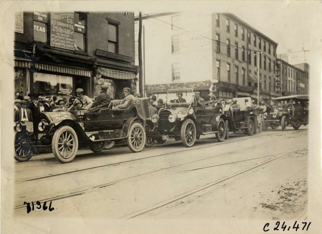 Automobiles lined up in street, 1911 Glidden Tour