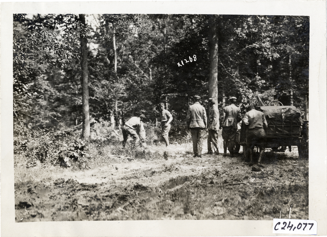 Motorist chopping tree, 1910 Glidden Tour