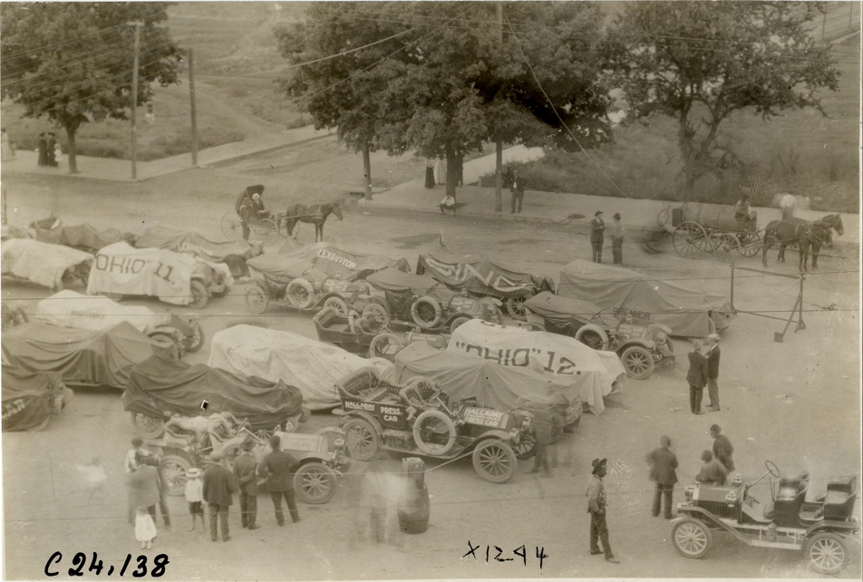Automobiles parked in street, 1910 Glidden Tour