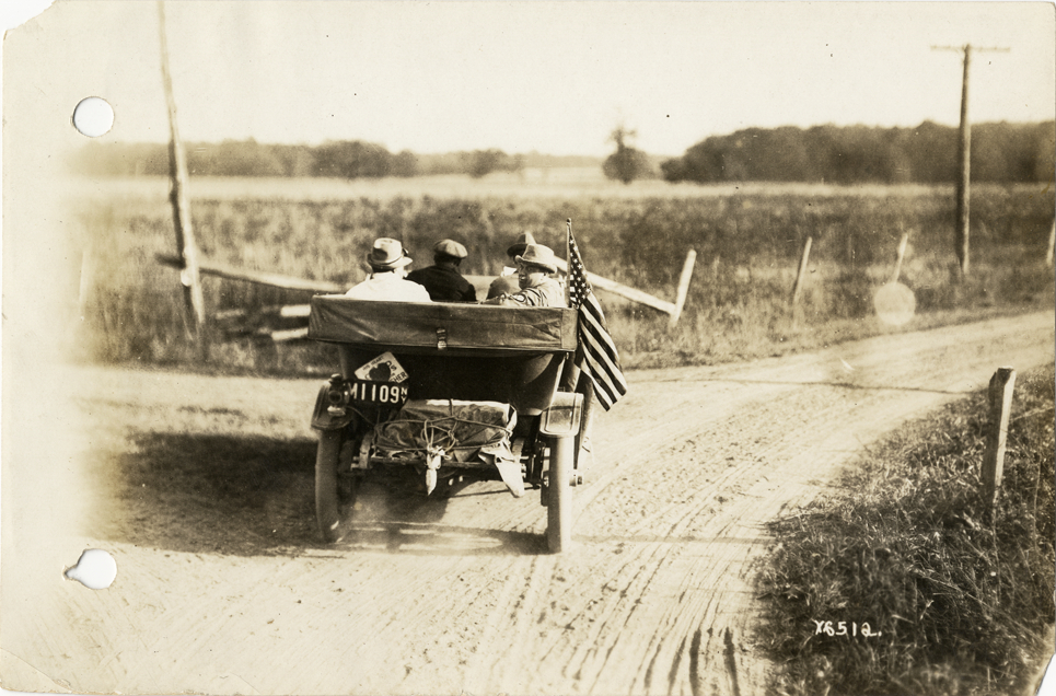 Motorists in automobile traveling on rural road, 1912 Glidden Tour