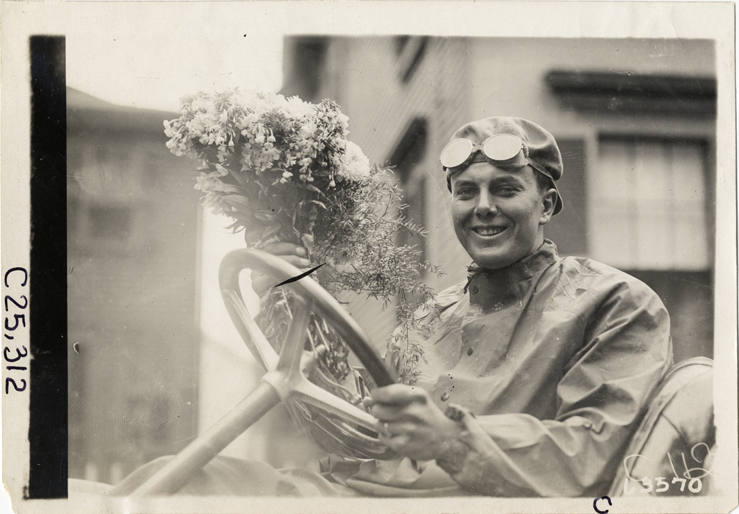 Driver holding bouquet of flowers, 1910 Munsey Historic Tour