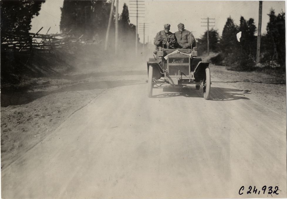 Motorists in Maxwell automobile traveling on rural road, 1909 Harrisburg Endurance Run
