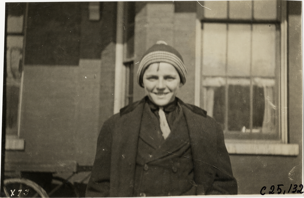 Driver posing in front of building, 1910 Hupmobile Detroit to New York tour