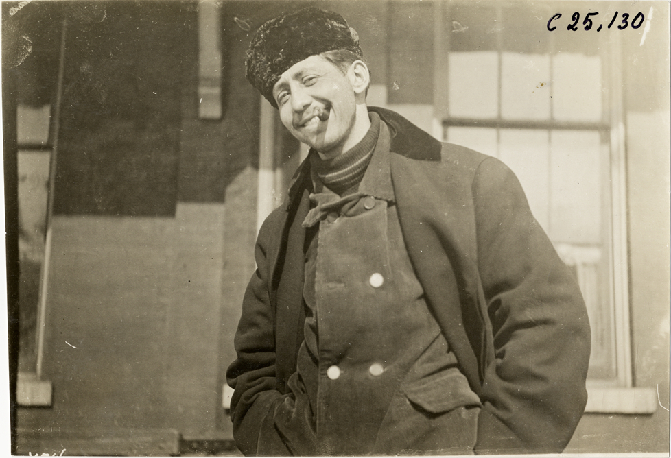 Driver posing in front of building, 1910 Hupmobile Detroit to New York tour