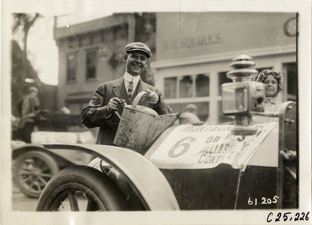 Motorist filling radiator of Palmer-Singer automobile, 1910 Montauk Point Reliability Run