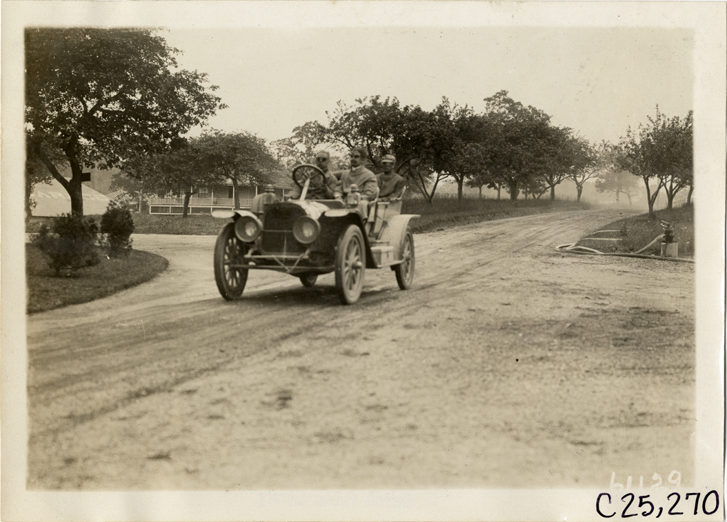 Motorists in automobile traveling on rural road, 1910 Montauk Point Reliability Run