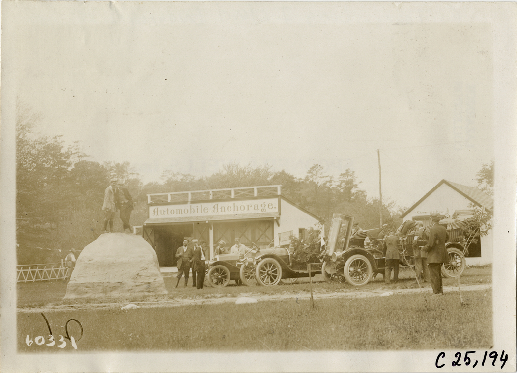 Two men standing atop rock on the grounds of Anchorage Inn, 1910 Long Island Endurance Run