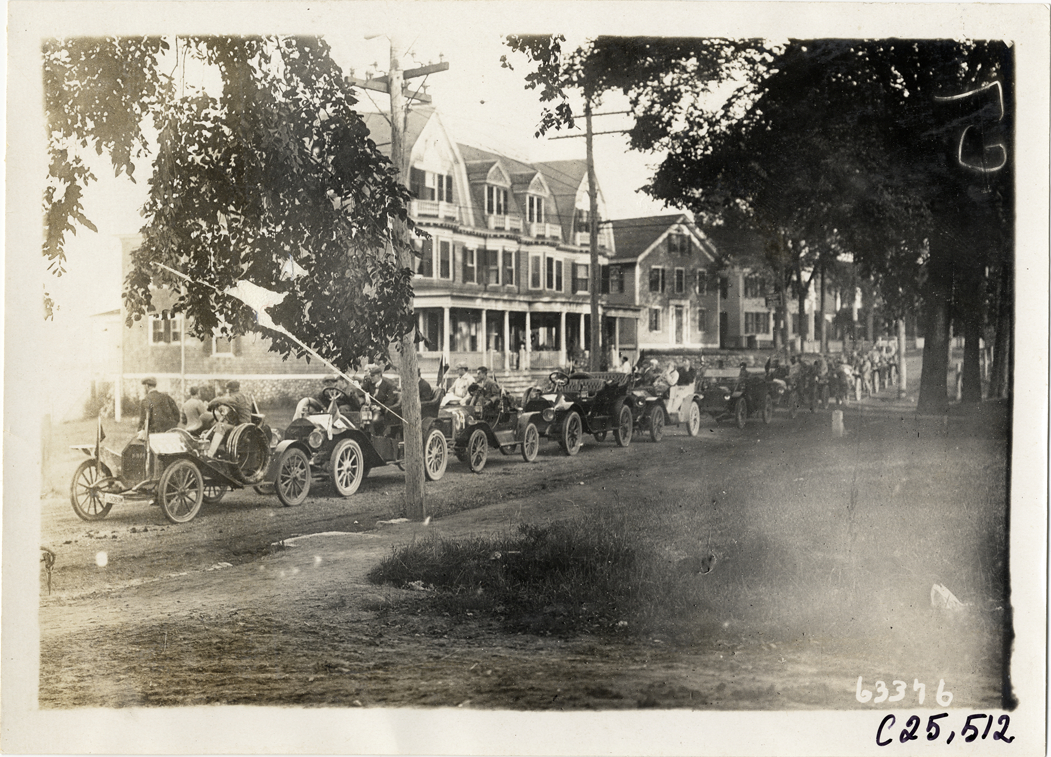Automobiles lined up in street, 1910 Munsey Historic Tour
