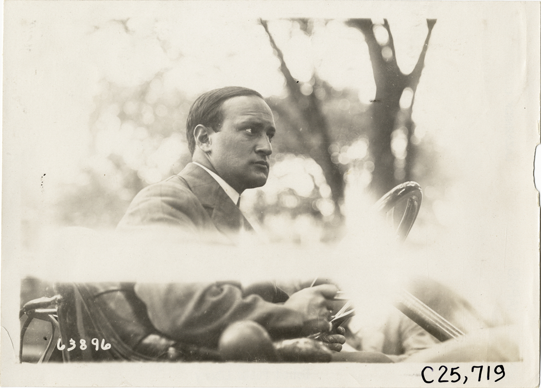 Driver in automobile, 1910 Munsey Historic Tour