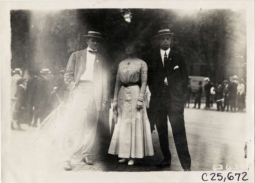 Two men posing with woman under tree, 1910 Munsey Historic Tour