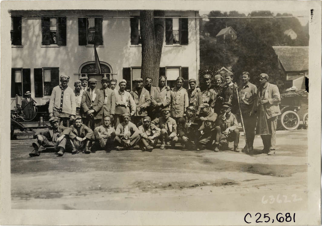 Motorists posing in front of house, 1910 Munsey Historic Tour