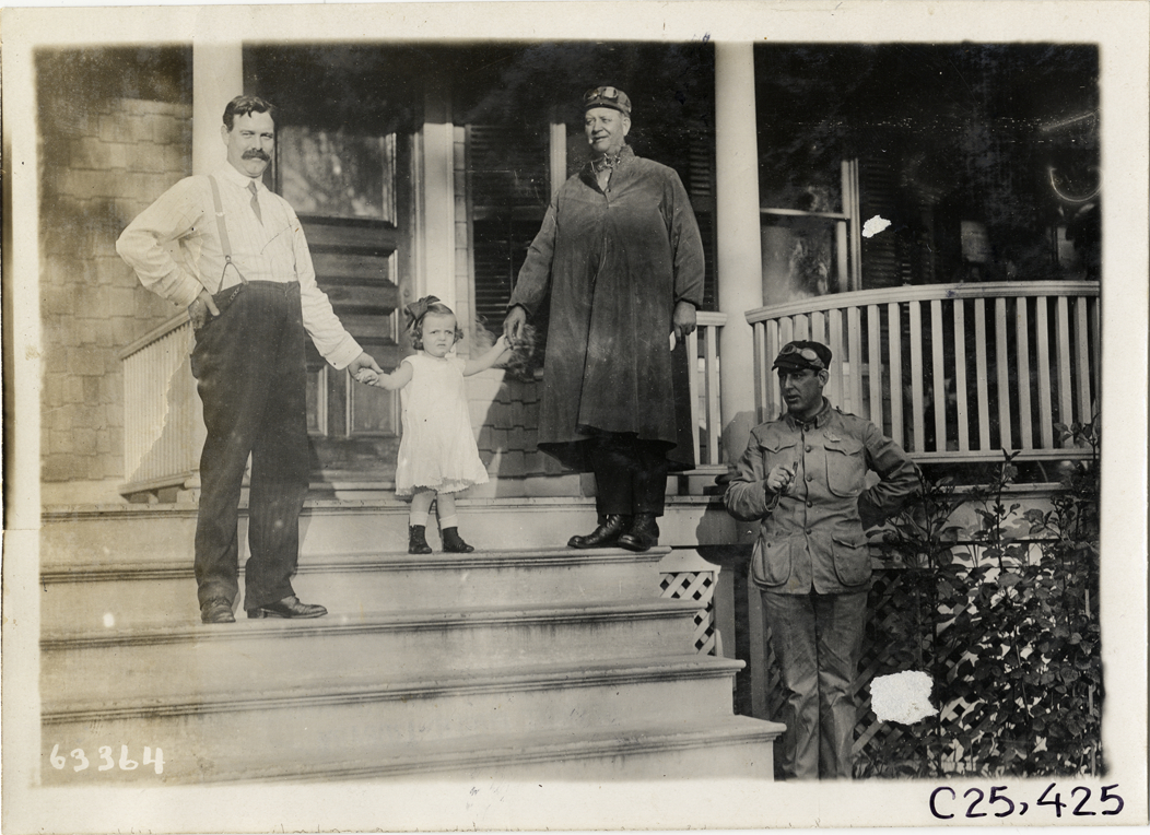 Three men and young girl posing on porch steps, 1910 Munsey Historic Tour