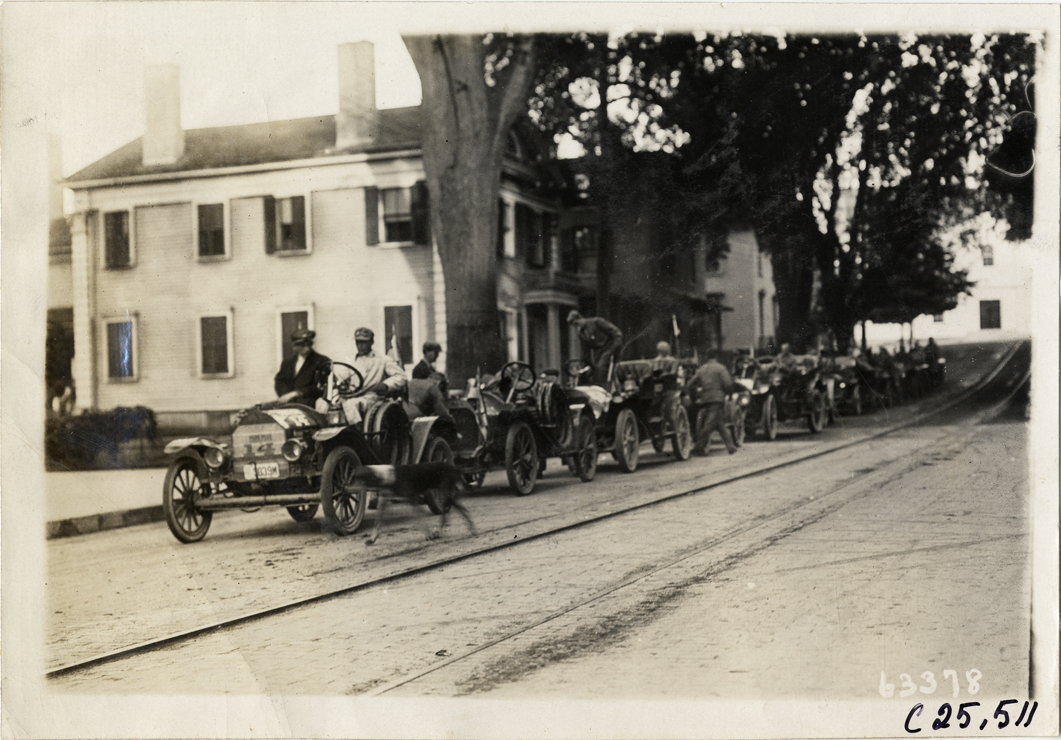 Automobiles lined up in street, 1910 Munsey Historic Tour