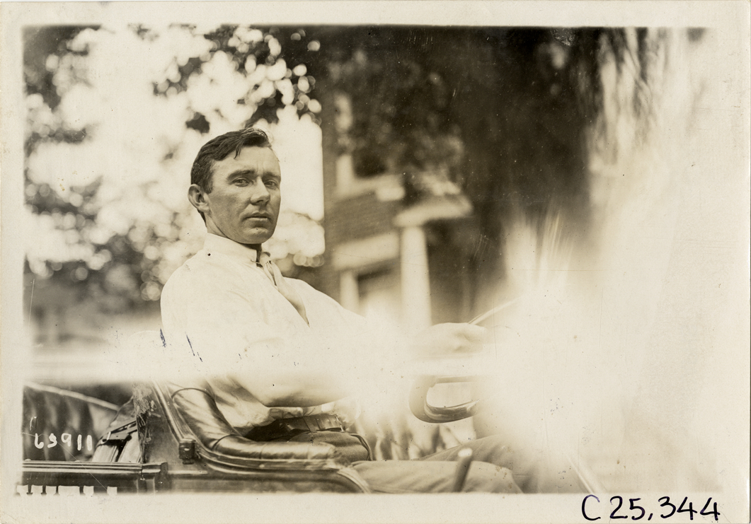 Driver in automobile, 1910 Munsey Historic Tour