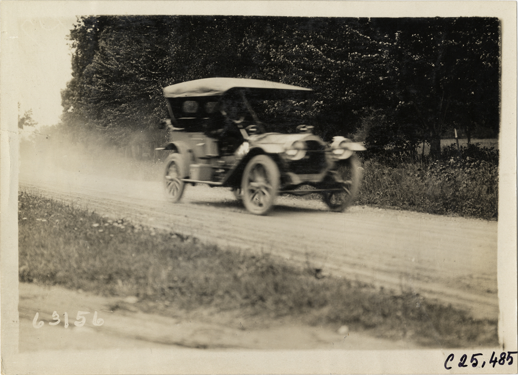 Automobile traveling on rural road, 1910 Munsey Historic Tour