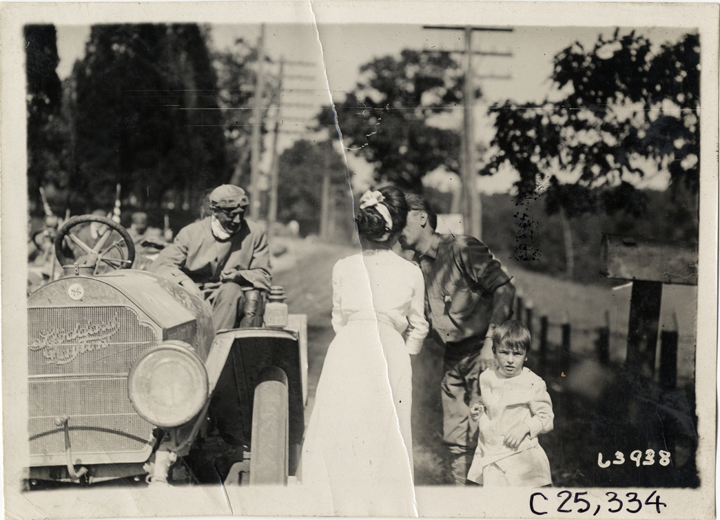 Couple kissing next to Stoddard-Dayton automobile, 1910 Munsey Historic Tour