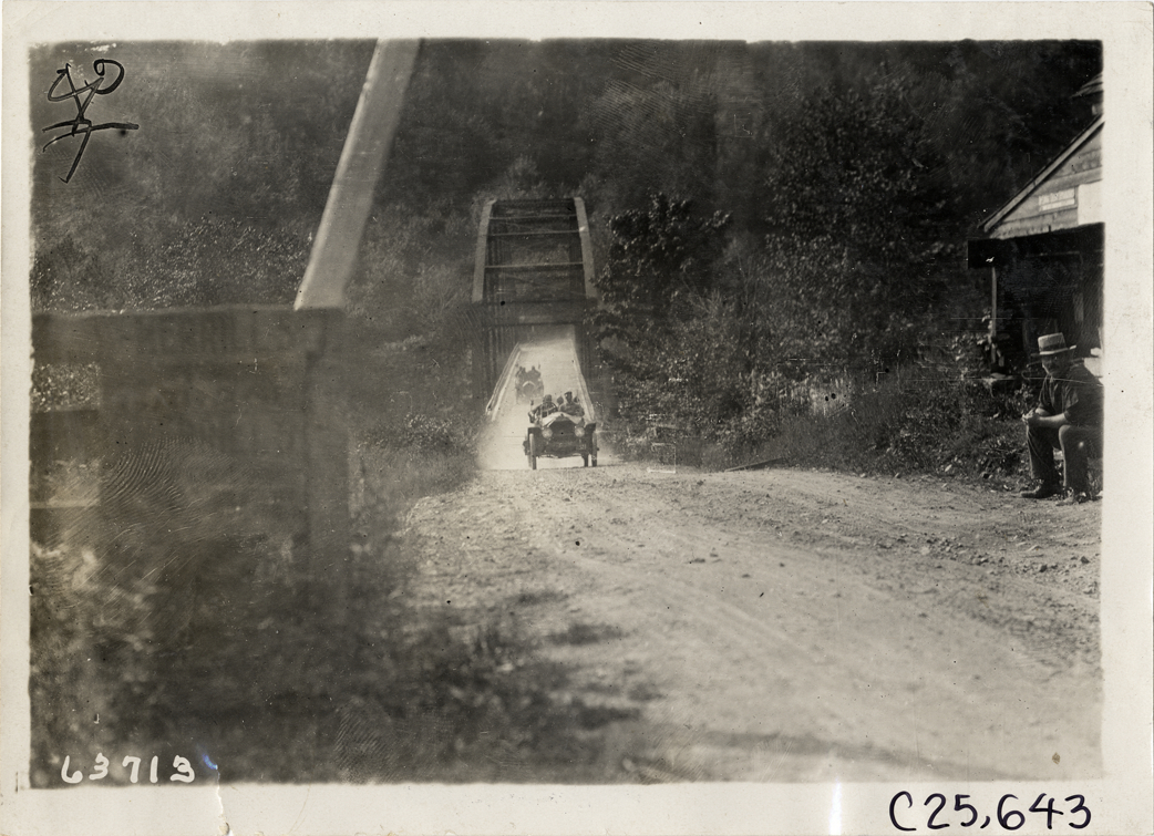 Automobiles crossing toll bridge, 1910 Munsey Historic Tour