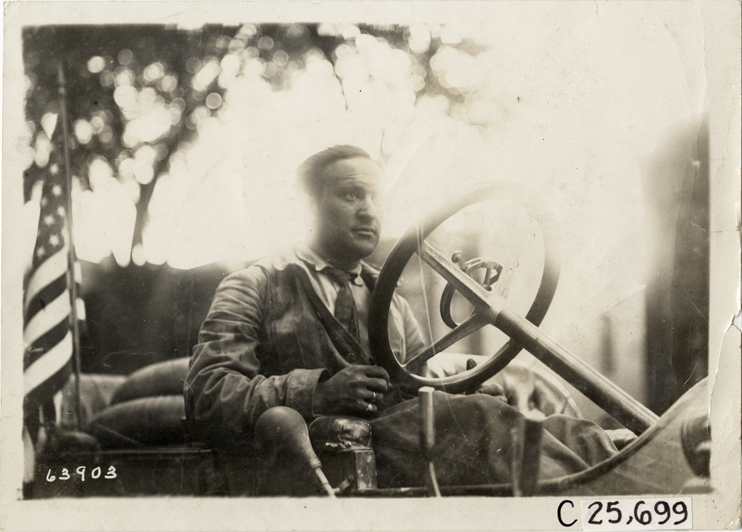 Driver posing in automobile, 1910 Munsey Historic Tour