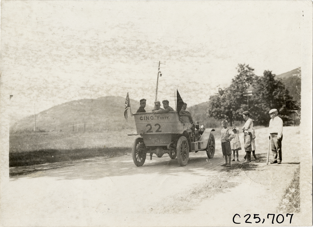 Motorists posing in Cino automobile on rural road, 1910 Munsey Historic Tour
