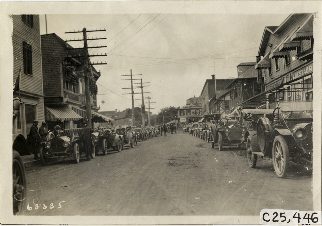 Automobiles parked in street, 1910 Munsey Historic Tour